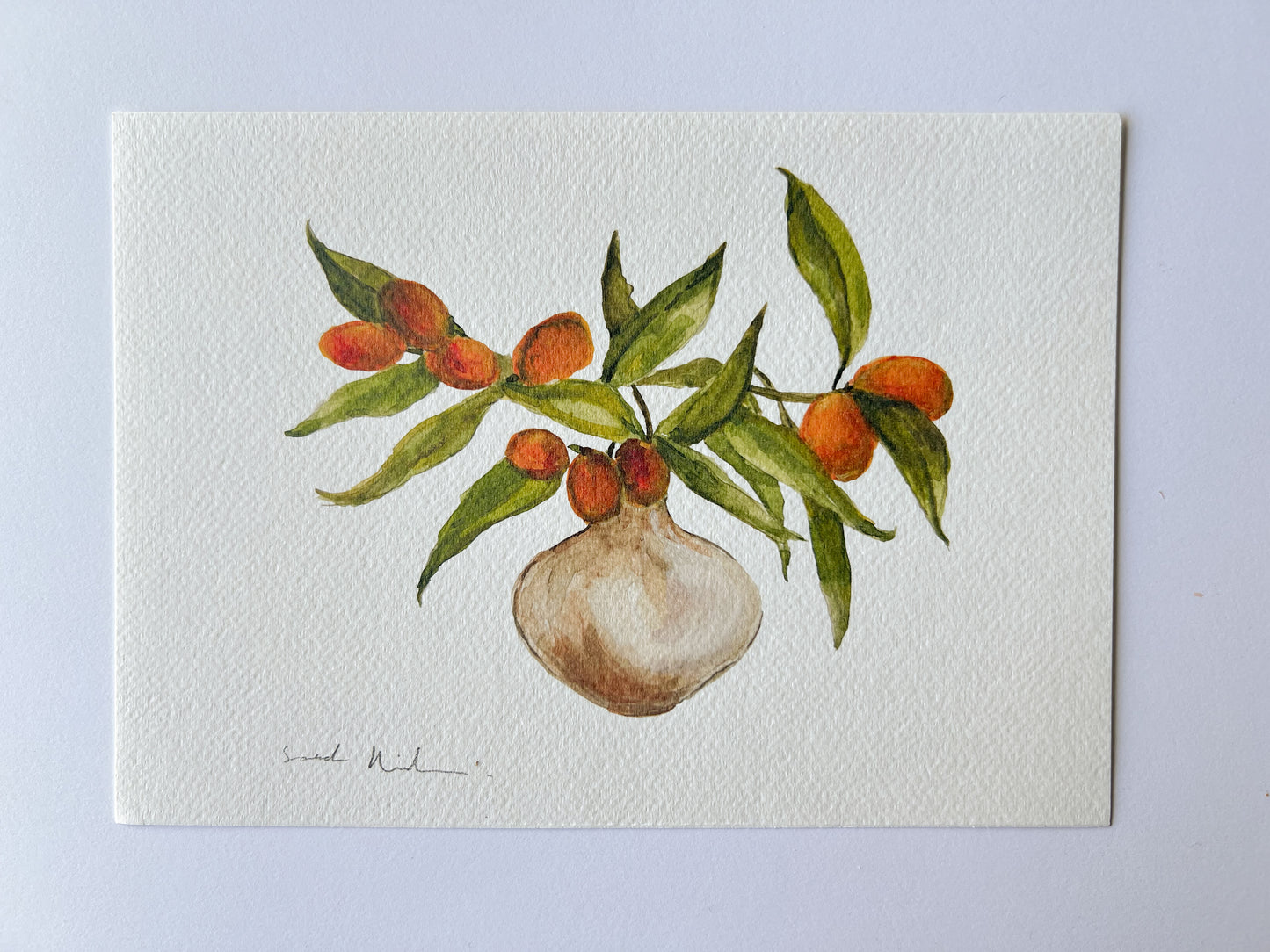 Jarrón con rama de kumquat